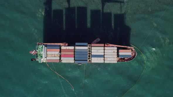 Aerial View of a RISE SHINE Container Cargo Ship Stands Aground After a Storm with Floating Boom alt