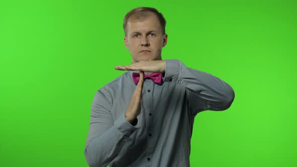 Man Showing Time Out Sign. This Is Limit, Enough Gesture. Portrait of Guy on Chroma Key Background alt