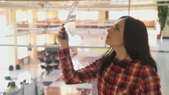 Brunette in the Light Looking at X-ray Picture in Lobby the Clinic. alt