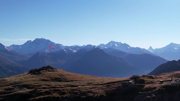 Beautiful aerial in mountain panorama with matterhorn, swiss flag and one hiker alt