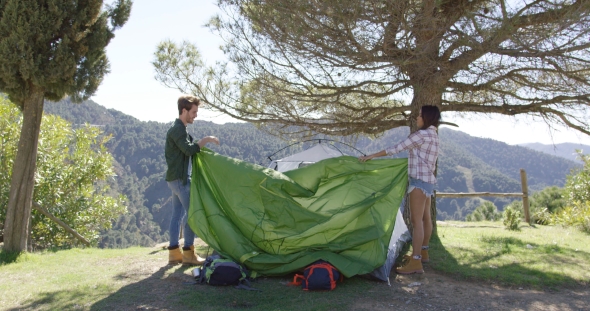 Two Travellers Putting Up Tent alt