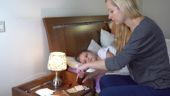 Mother Giving Medicine to her Sick Kid