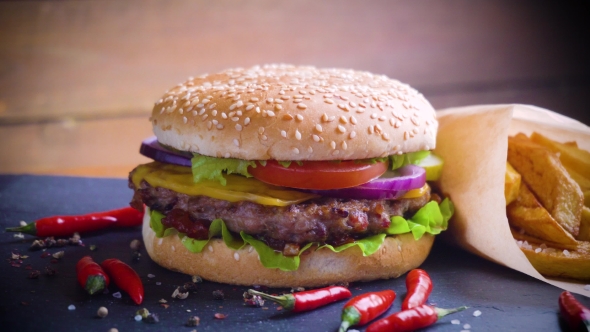 Tasty Homemade Hamburger with Potatos Served on Stone Plate