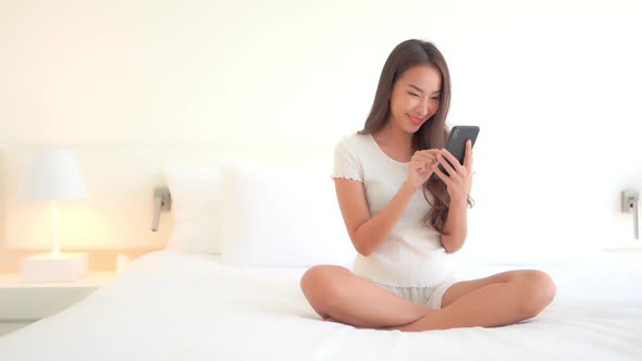 Young asian woman use smart phone alt