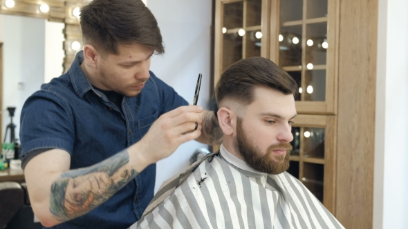 VideoHive Master Cuts Hair and Beard in the Barber Shop Black Gloves with Tattoos Off of Hands 19618328 VideoHive Master Cuts Hair and Beard in the Barber Shop Black Gloves with Tattoos Off of Hands 19618328