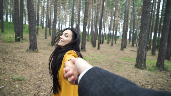 Woman Is Walking in the Woods with a Young Man