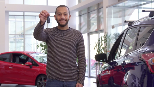 Guy Holds Car Key in His Hand alt
