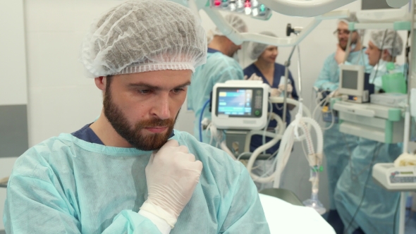 Surgeon Touches His Beard alt
