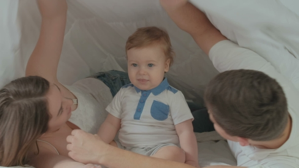 VideoHive Happy Family with Baby Boy Under Blanket on Bed 19622218 VideoHive Happy Family with Baby Boy Under Blanket on Bed 19622218