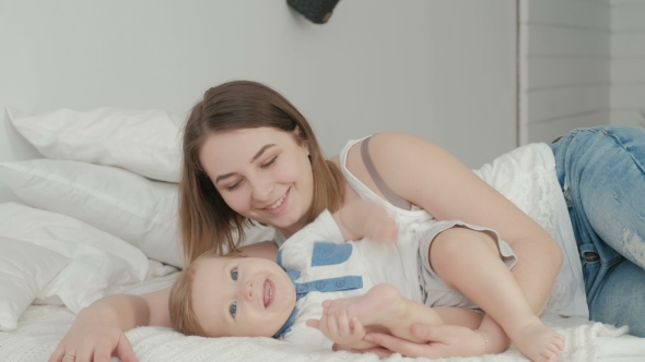 VideoHive Mother and Child on a White Bed Mom and Baby Boy in Diaper Playing in Sunny Bedroom 19622231 VideoHive Mother and Child on a White Bed Mom and Baby Boy in Diaper Playing in Sunny Bedroom 19622231