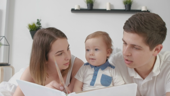 Mother and Father Read the Book Before Going To Bed, the Little Son alt