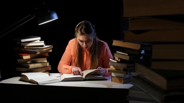 Girl Goes Through the Book and Find the Right Information. Black Background alt