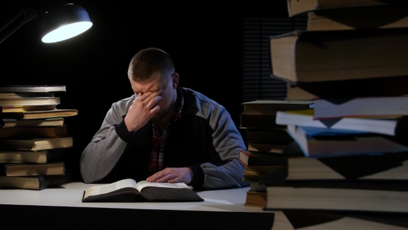 Guy in the Lamplight Records Information on Paper and Crumples It. Black Background alt