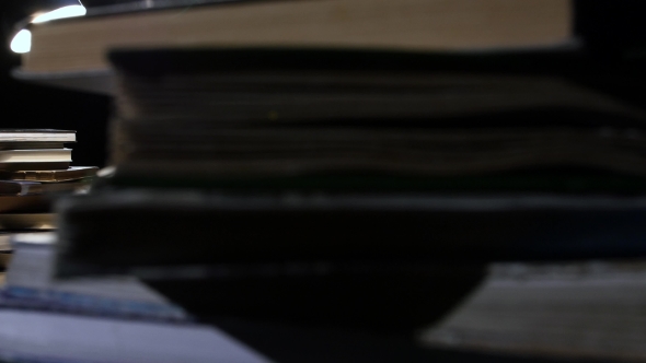 Man Reading a Book and Writes in a Notebook. Black Background alt