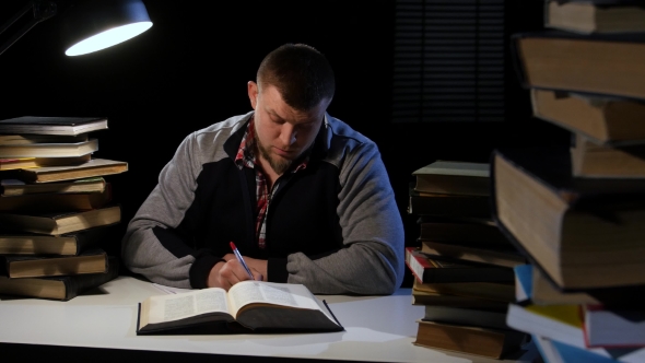 Guy in the Lamplight Records Information on Paper and Crumples It. Black Background alt