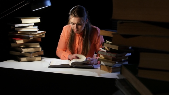 Girl Goes Through the Book and Find the Right Information. Black Background alt
