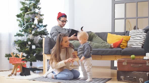 Happy Young Family at Home in Christmas