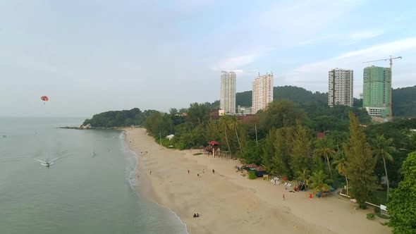 A drone shot of the beach at Batu Ferringhi on Penang, Malaysia. alt
