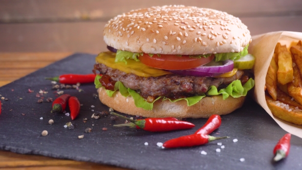 Tasty Homemade Hamburger with Potatos Served on Stone Plate