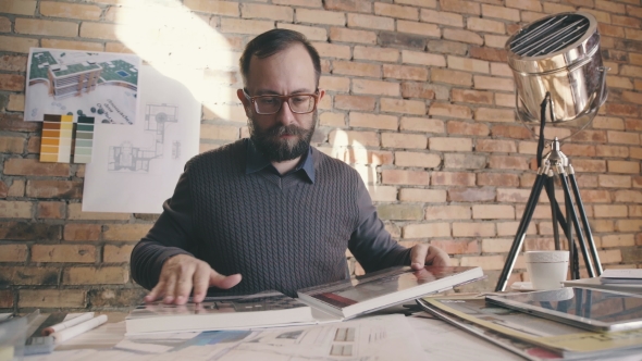 Stylish Hipster Man Working While Sitting at a Table
