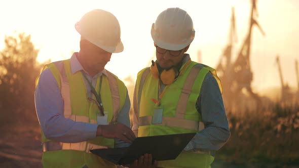 Engineering Colleagues are Discussing Project Plans at Sunset alt