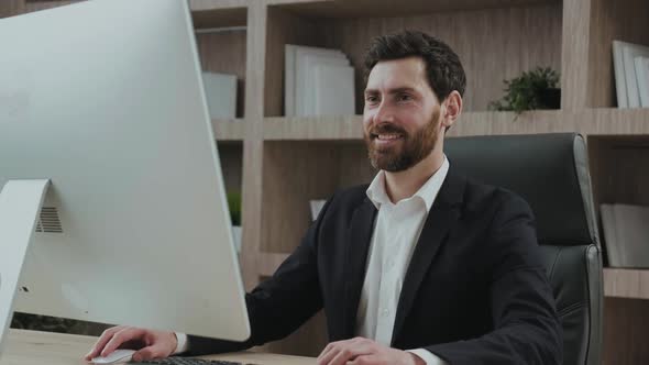 Close Up Portrait View of a Manager at His Workplce Nodding Looking at His Screen Working at His alt