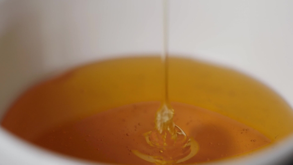 Thin Honey Trickle Against a Black Background alt