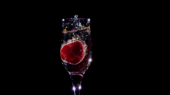 . Fresh Strawberry Falling in Glass with Champagne Wine alt
