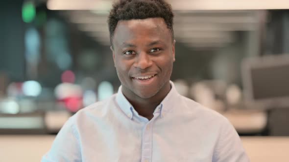 Portrait of African Businessman Shaking Head As Yes Sign alt