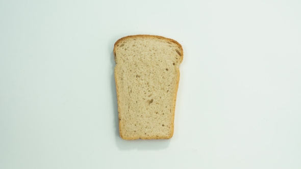 A Slice Of Bread Over White Background Bite Off Pieces Of The Bread