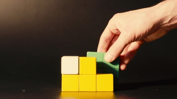 Man's Hand Picking 3D Tetris