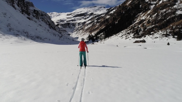 Woman Classic Skiing Near High Mountains