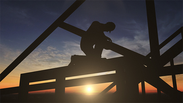 Silhouette Of Construction Worker On Roof Top