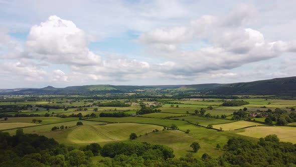 Drone Hyperlapse Over Patchwork Fields in North York Moors with Clouds alt