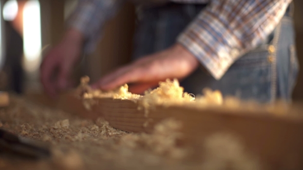The Carpenter Sweeps the Shavings off the Wood with Wood