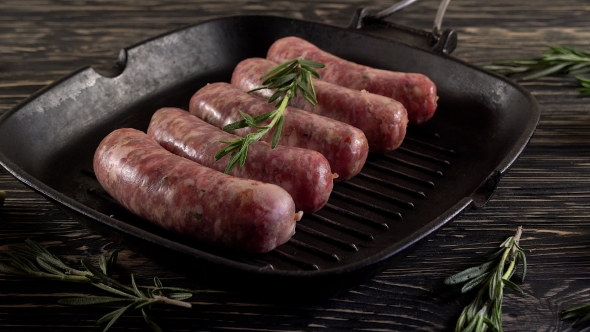 Raw Sausages Rosemary on Wooden Surface