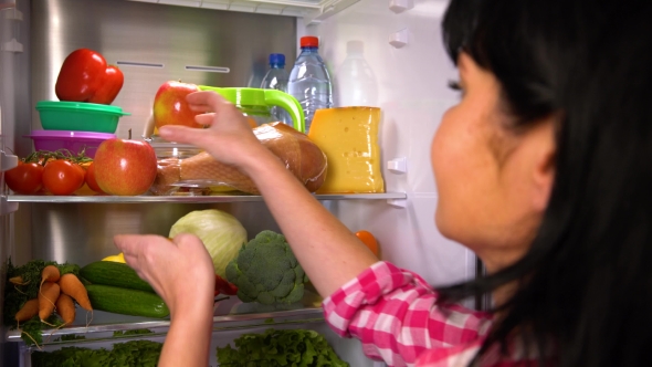 Woman Picks an Apple or Meat