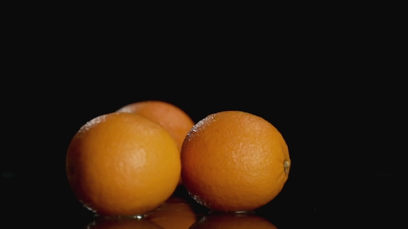Oranges Falling on Dark Background