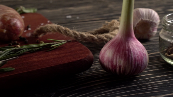 Raw Sausages with Garlic, Rosemary on Wooden Surface