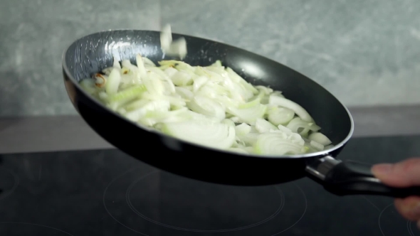 Chef Fryes Onion in a Hot Frying Pan, Vegetables Are Cooked, Meals with Vegetables alt