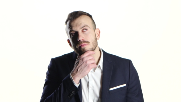 Businessman in Black Suit Thoughtful and Rubs His Hand Beard alt