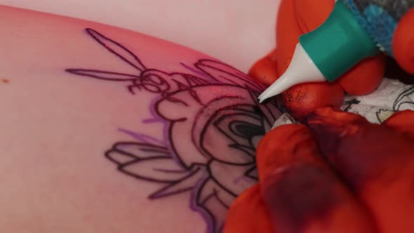 Tattoo Artist Makes a Tattoo Woman on a Arm, Works in Studio in Red Light. Slow Motion Close View alt