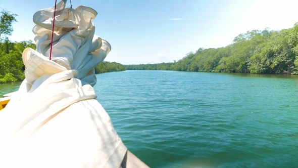Boat Sailing on a River Towards the Sea alt