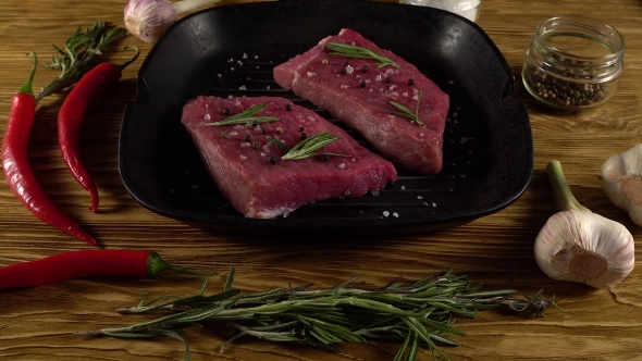 Beef Fillet on a Pan with Pepper, Rosemary and Garlic.