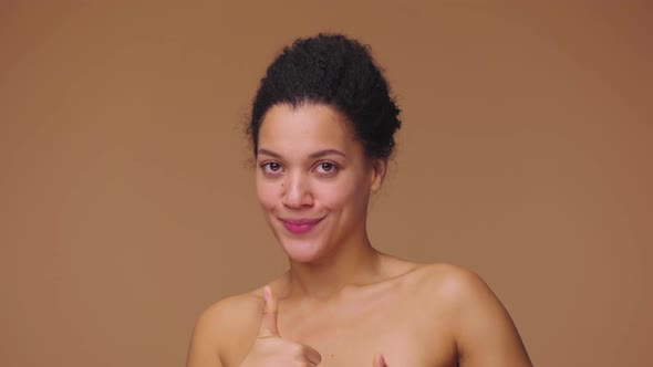 Beauty Portrait of Young African American Woman Pointing Up Hand for Something Then Nods and Shows alt