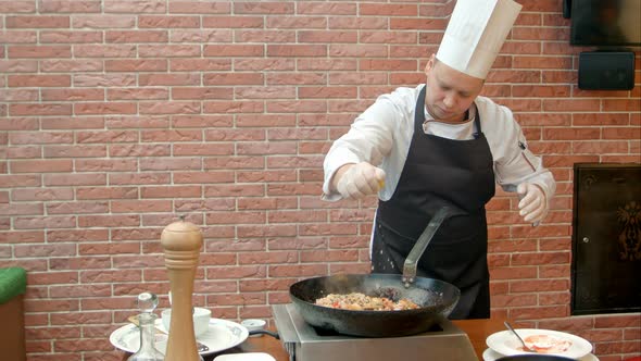 Chef Squeeze Lemon Juice Into Pan with Paella alt