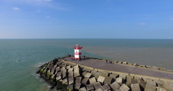 Aerial Shot of North Sea with Lighthouse and Pier. Drone Flying Above Sea in Hague