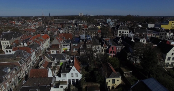 Aerial Footage of the City Roofs and Canal in Netherlands. Drone Flying Above Houses in Holland