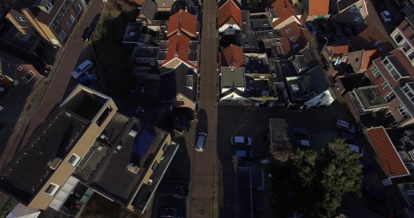 Aerial Footage Above Roofs of the Houses. Drone Flying Over the City Roofs and Road in Holland