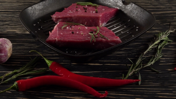 Beef Fillet on a Pan with Pepper, Rosemary and Garlic.